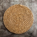 Top view of a round hand-woven natural straw heat-resistant placemat on grey surface - 30*40cm / Premium Double Strand Cattail
