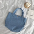 Detail of light blue corduroy tote bag featuring a vintage bronze metal snap button closure - Aquamarine