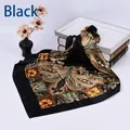 Detail of a black square silk scarf featuring a vintage paisley pattern on a white backdrop - Black