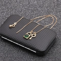 Close-up of gold lock and key jewelry set with green gemstone on black velvet box - Style 4 Green Gemstone Lock and Key