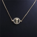 Halloween gold skull pendant necklace with diamond-encrusted circular border on black backdrop - Skull Style 5 Gold