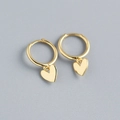 Macro shot of gold heart dangle hoop earrings in 925 sterling silver on grey background - 925 Silver / Gold
