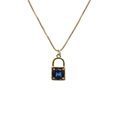Macro shot of gold lock pendant necklace with a square blue zircon gemstone detail - Lock 9 Blue-Sapphire Lock