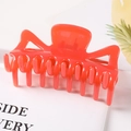 Detail of bright orange hollow hair claw clip with glossy resin finish for daily styling - Red / 9.5CM