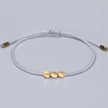 Handmade woven cord bracelet in light blue with three irregular gold-toned copper beads - Light Blue