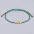 Handmade woven dark green rope bracelet with three matte gold copper beads and adjustable drawstring - Dark Green