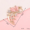 Detailed view of a golden peacock brooch with pink crystal and white rhinestones - D178 Peacock (Pink)