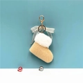 Detail of plush Christmas boot keychain with sheer bow and golden metal lobster clasp - Beige