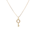 Detail view of a gold key pendant with micro-pave zircons and a small heart on a box chain - Heart Decor Key - Gold