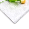 Detail of white tissue paper featuring silver glitter snowflake patterns for gift wrapping - Silver Snowflake