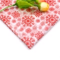 Close-up of red and white snowflake pattern tissue paper with decorative yellow roses - Snowflake Red