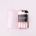 Macro detail of 7-piece pink makeup brush set in a compact transparent travel case - Pink