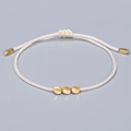 Handmade white woven cord bracelet featuring three irregular matte gold beads - White