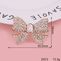 Rose gold bowknot brooch with rhinestones on a white plate over pink background - D073 Large Gem Bow