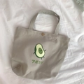 Detailaufnahme der Canvas-Lunchtasche mit Avocado-Print und bronzefarbenem Metalldruckknopf - Graue Avocado