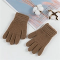 Detail of warm brown knitted wool gloves for children with cozy winter texture - 2-11 Years / Coffee