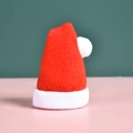 Miniature red and white felt Santa hat decoration for Christmas on a pink surface - Mini Christmas Hat Cutlery Cover
