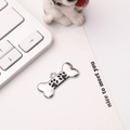 Zinc alloy bone dog tag featuring a black paw print charm on a desktop setting - 30*15mm / Black