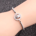 Pulsera de calavera con dijes de circonita y cordón negro trenzado ajustable para hombre - Oro Blanco