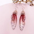 Detailed macro view of S925 silver butterfly wing earrings with red gradient and rhinestones - Red Rhinestone-Rose Gold