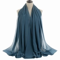 Detail of dark teal chiffon scarf with textured pleats and smooth hem on a mannequin - Twilight Blue