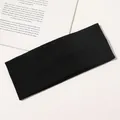 Close-up of black ribbed knit yoga headband with high elasticity and soft texture - Black