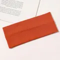Detail view of the caramel orange ribbed cotton yoga headband with fine knit texture - Orange
