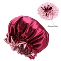 Detail view of reversible satin sleep cap in wine red and pink with elastic band - One Size / Burgundy
