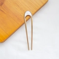 Minimalist U-shaped gold metal hair pin with a translucent white geometric decorative top - U-Shaped Light Shell