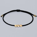 Handwoven black string bracelet featuring three matte gold beads with adjustable closure - Black