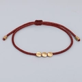 Handmade woven red cord bracelet featuring three irregular matte gold copper beads - Reddish Brown