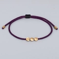 Handmade woven purple bracelet with three matte gold beads and adjustable black cord - Deep purple