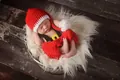 Macro detail of handmade crochet baby Christmas outfit with red hat and shorts - Pants 2-Piece Set