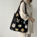 Detail of a black canvas tote bag featuring various cute dog illustrations and Dogs text - Dog Illustration / Black