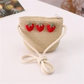 Beige woven straw crossbody bag for girls featuring three red strawberry ornaments - Three Strawberries Style / Beige