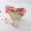 Kids woven straw crossbody bag in beige featuring a red gingham bow and pearl pendant - Bowknot Style / Cream