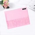 Pink cashmere scarf with fringe details laid on a background with roses and magazines - Hot Pink