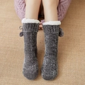 Gray thermal knit floor socks with plush white cuff and pom-pom detail on model - One Size / Dark Gray