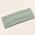 Macro detail of mint green ribbed knit yoga headband fabric showing texture and elasticity - Lake Green