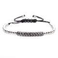 Macro detail of men's braided rope bracelet with silver beads and black zircon bar - White Gold Curved Tube