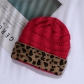 Detail of fuchsia knit beanie with leopard print cuff on a minimalist white background - One Size / Rose Red