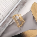 Elegant golden cat-shaped metal hair claw clip with cutout design on a feather - Small Gold Cat
