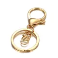 Close-up of a polished gold alloy keychain with swivel lobster clasp and flat key ring - KC Gold