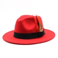 Detail of red wool fedora featuring a black ribbon band and colorful decorative feathers - M (56-58cm) / Red