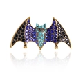 Vintage bat brooch in gold metal with navy and light blue rhinestones on white backdrop - Violet Blue