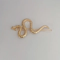 Close-up of golden snake hair clip with realistic scale texture on metal surface - No Rhinestone / Gold