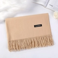 Elegant camel cashmere scarf with fringe detail laid on a stylish white fur background - Khaki