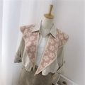 Pink knitted shawl with white flower pattern worn over a beige shirt and plaid skirt - Knitted Pointed Floral Pink