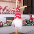 Red Christmas gnome ornament with snowflake embroidery and white beard hanging on a rack - Red Wave Pattern Style