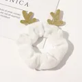 Close-up of white plush Christmas scrunchie with sparkling gold reindeer antlers - White Reindeer Velvet Scrunchie